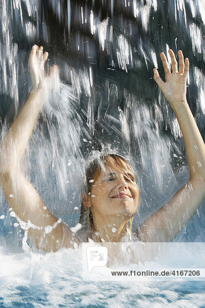 Eine Frau Empf Ngt Mit Empor Gestreckten Armen Und H Nden Das Wasser Eines Wasserfalls Ber