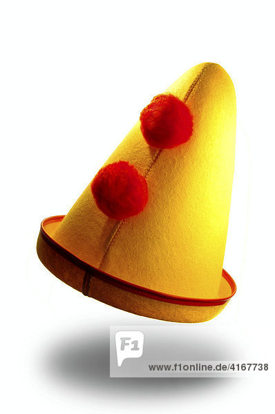 Ein gelber Karnevalshut mit roten Bömmeln