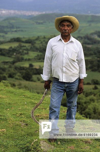 Mexico Michoacan San Felipe de los Alzati - farmer with sickle