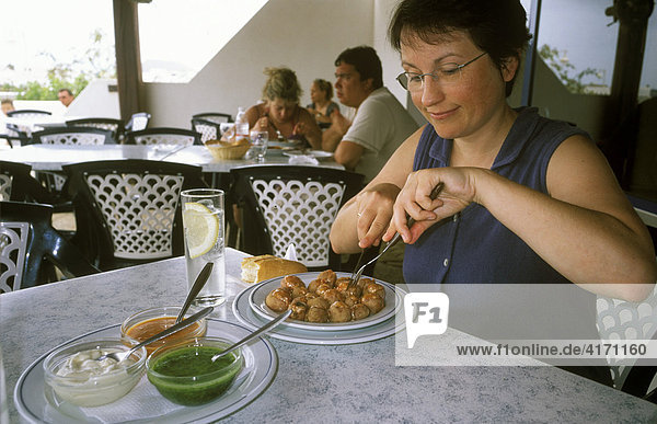 Woman eating Papas arrugadas  Caleta de Sebo  La Graciosa  Canary Islands  Spain