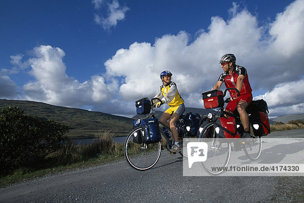 Trekking bikers  couple  Killary Bay  Connemara  Ireland