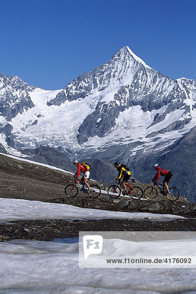 Mountain bikers in front of Mt. Weisshorn  Zermatt  Valais  Switzerland  Europe