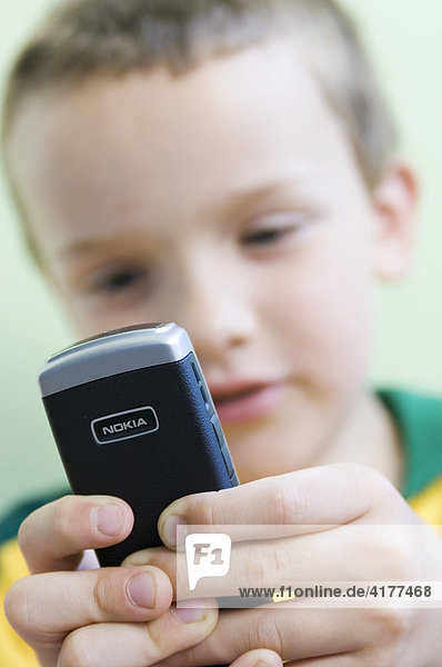 Boy playing with a Nokia mobile phone