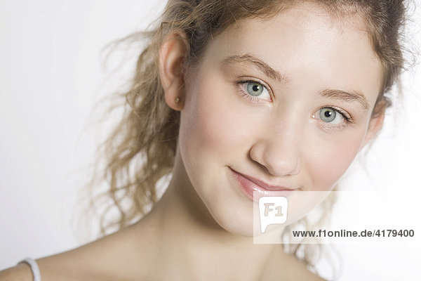 Smiling young woman in front of a white background