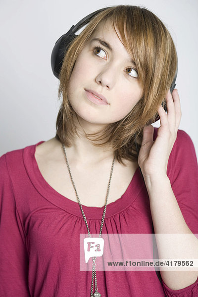 Teenager listening to music with headphones