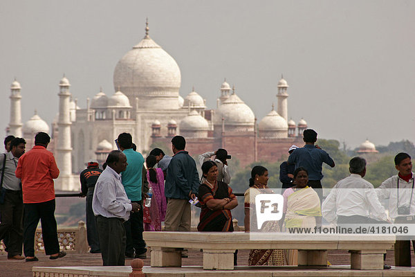 Indian tourists visiting the Red Fort of Agra  with the Taj Mahal in the background  Agra  Uttar Pradesh  India  Asia