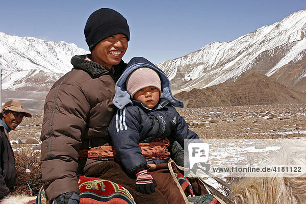 Man and child riding horseback near Jharkot in the Himalayas  Nepal  Asia