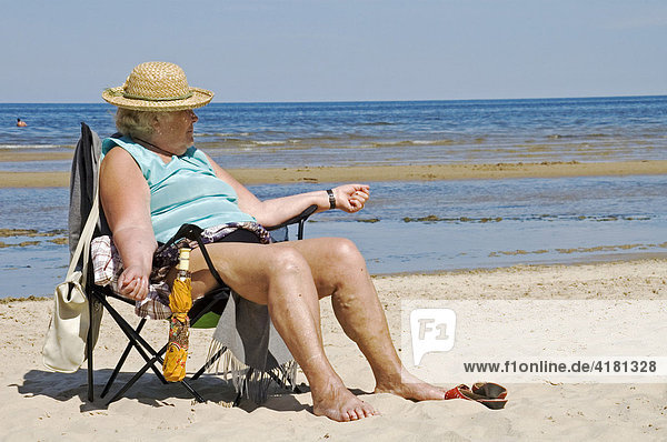 Femal senior enjoys the sun  beach life in Jurmala near by Riga  Litvia  Baltic States