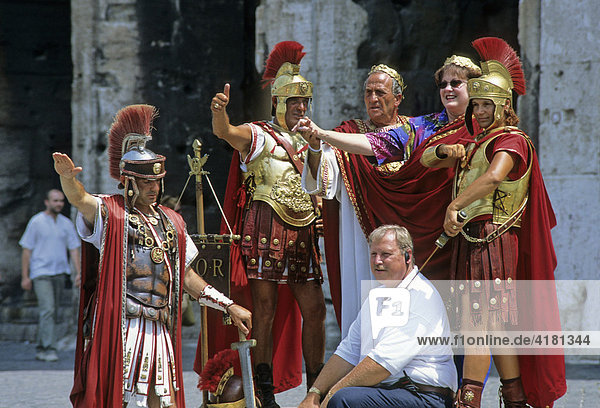 Tourists posing with costumed Roman legionaries being photographed at the Colosseum  Rome  Latium  Italy