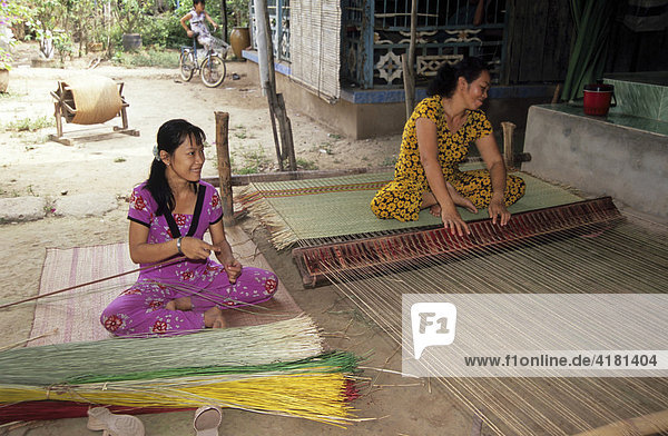 Women weaving sleeping mats  Mekong Delta  Vietnam  Asia