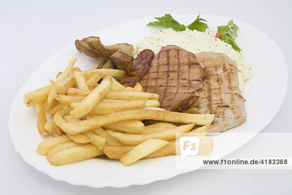 Grilled cutlets served with coleslaw and french fries