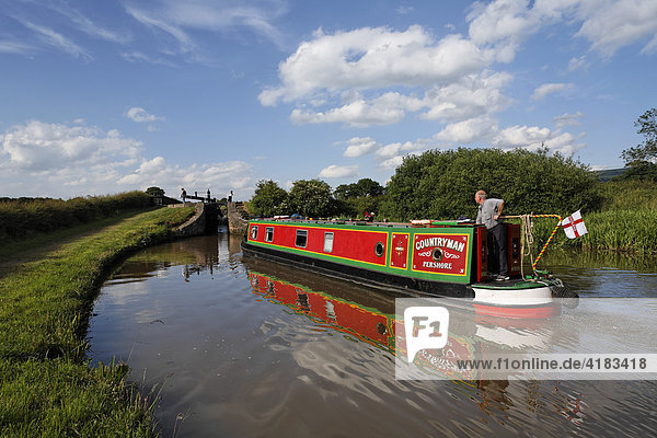 Boat in chanal in front of lock  Cheshire  England