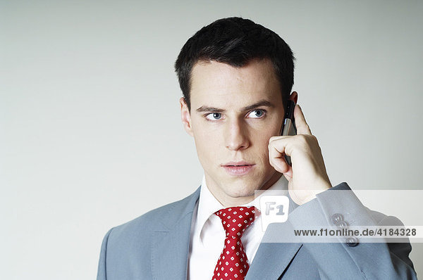 Young businessman making a call with his mobile phone