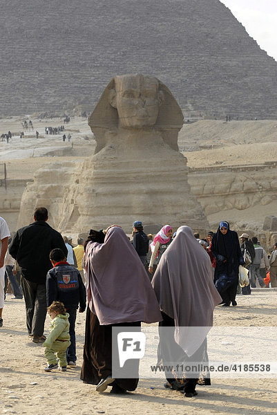 Die Pyramiden in Gizeh. Moslemische Frauen mit Schleier vor der Sphinx und der Chephren Pyramide  Gizeh  Kairo  Ägypten