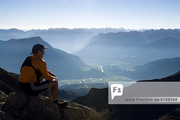 Mountain climber looking out over the Inntal (Inn Valley) in early morning  Imst  Tirol  Austria  Europe
