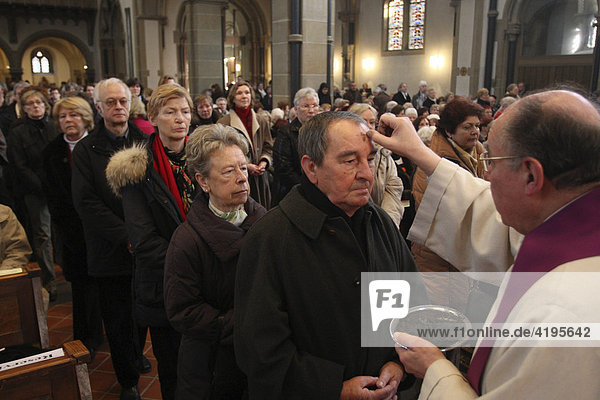 Pastor Helmut Kusche ashing parishioners' foreheads on Ash Wednesday at the Herz-Jesu Church in Koblenz  Rhineland-Palatinate  Germany  Europe