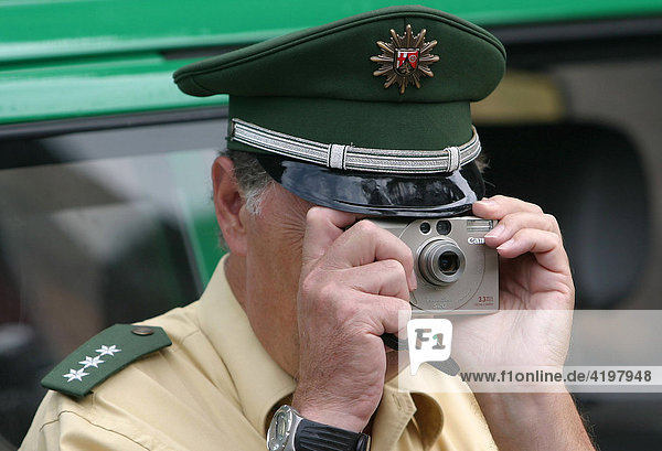 A german Policeman takes a photo