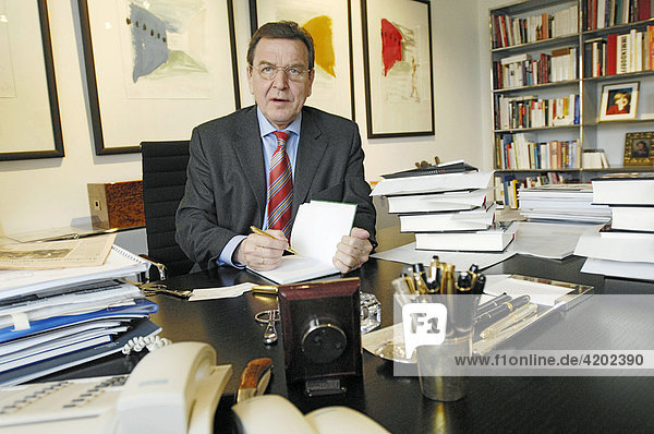 At his office desk with his new book Entscheidungen. Mein Leben in der Politik. Interview in his office in Berlin - Unter den Linden 50. Gerhard Schroeder SPD former Federal Chancellor   Berlin.