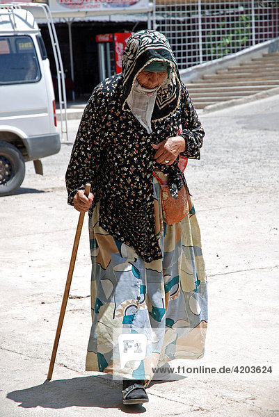 Elderly Turkish woman walking with cane  Katha  Anatolia  Turkey  Asia