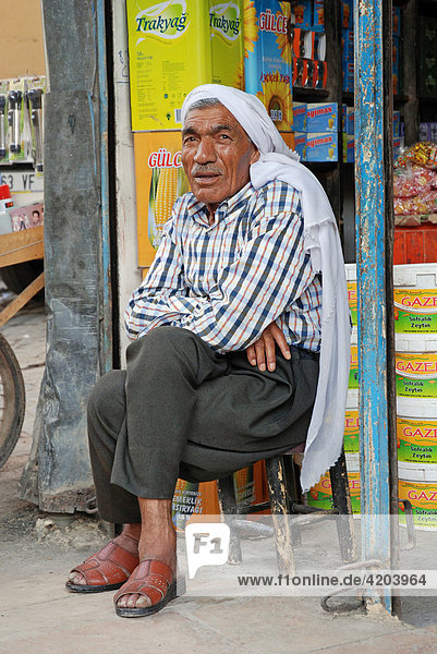 Kurdish man sitting in front of his shop  Urfa (Sanliurfa)  Anatolia  Turkey  Asia