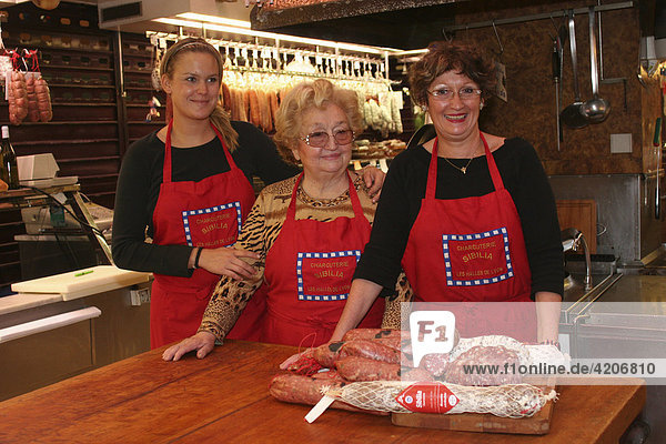 Three saleswomen standing at the Sibilia deli counter  Paul Bocuse market hall  Lyon  France