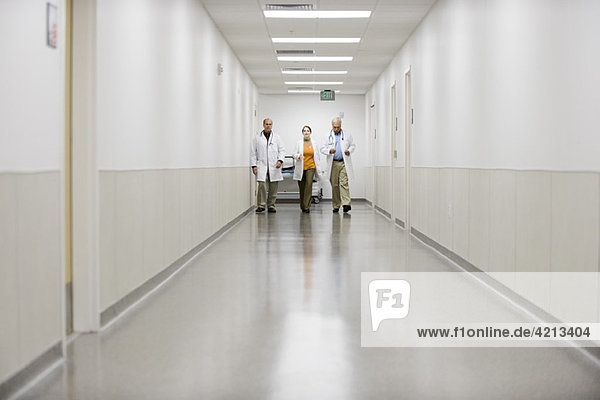 Doctors hurrying down hospital corridor