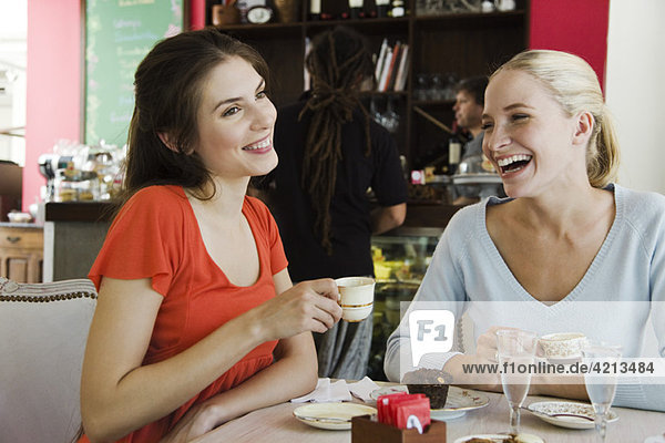 Female friends having coffee at cafe