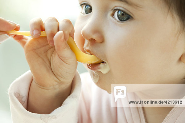 Infant learning to eat with a spoon