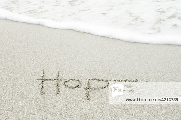 'The word ''hope'' written in the sand at the beach'