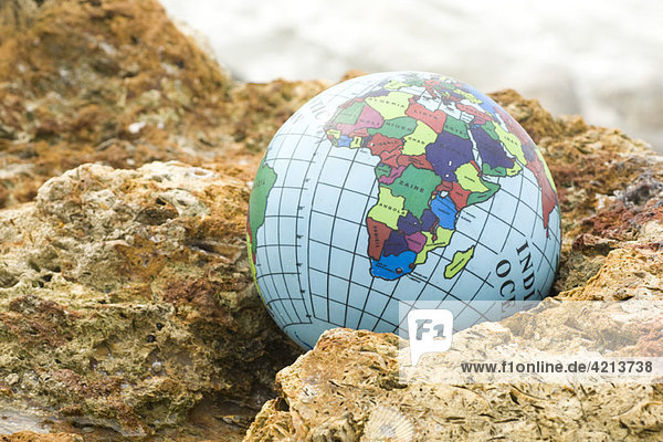Globe nestled in rock