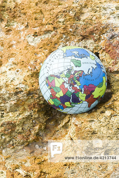 Globe nestled in rock