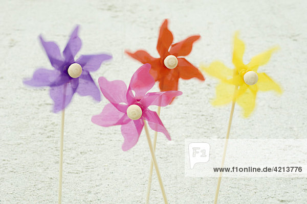 Pinwheels stuck in sand at the beach
