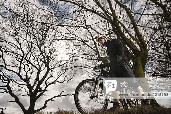 Man with mountain bike in countryside