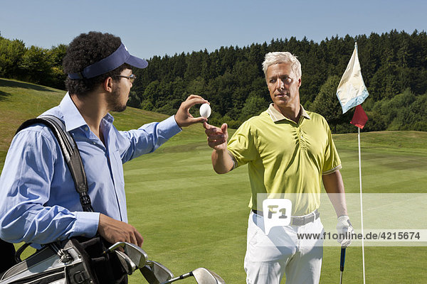 Caddy gives an egg to another golfer