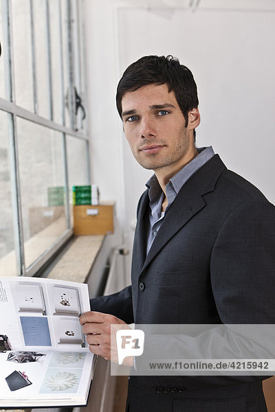 Business man reviewing a catalogue