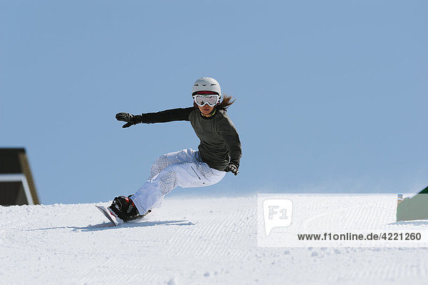 Woman with Arms Outstretched Snowboarden