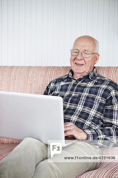 Elderly man with laptop