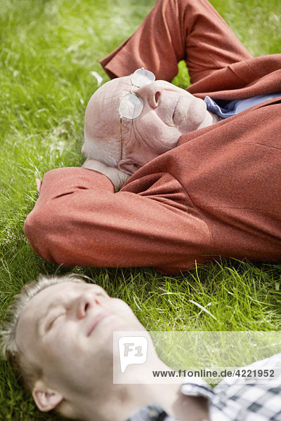 Senior and guy resting in the grass