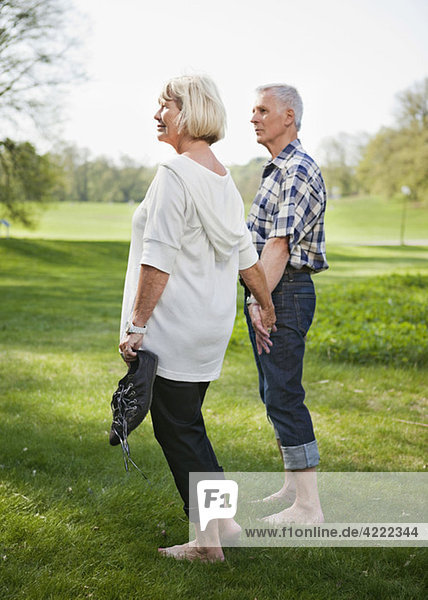 Old couple bare foot on lawn