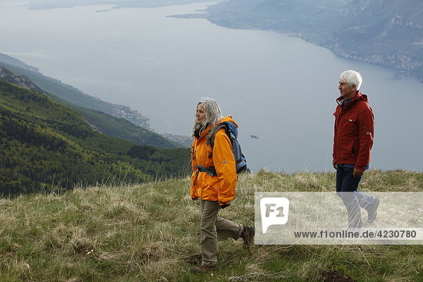 Senior couple hiking in mountain range  Italy  Monte Baldo