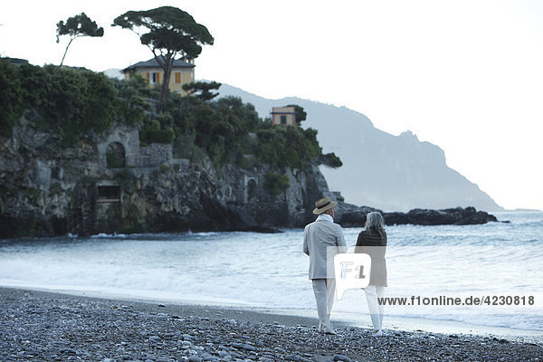 Senior couple walking on beach  Italy  Sori