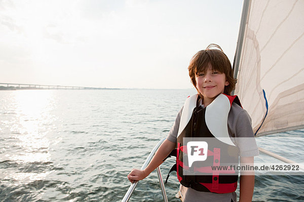 Young boy on board yacht