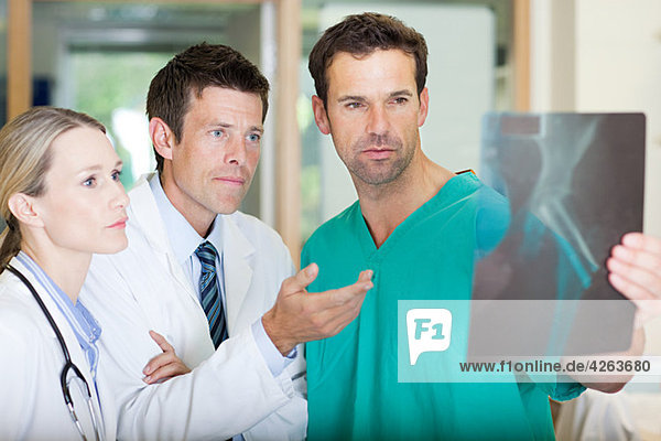 Doctors and surgeon looking at xray