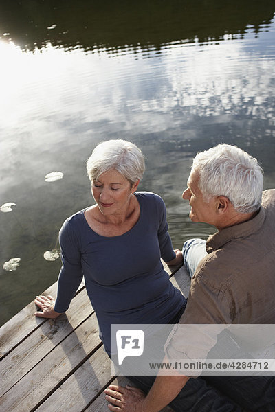 Senior couple flirting on jetty