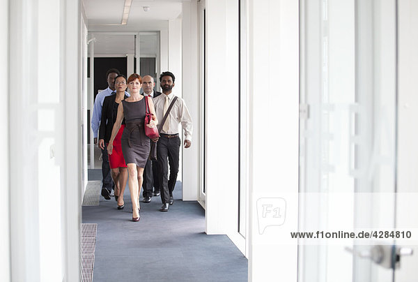 Business people walking down corridor