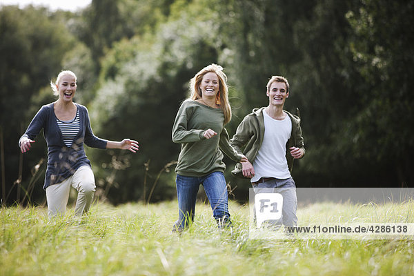 Young persons running in countryside