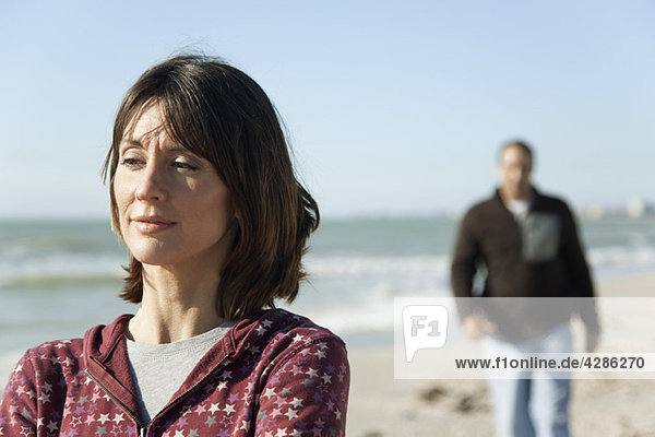 Woman at the beach  looking away in thought