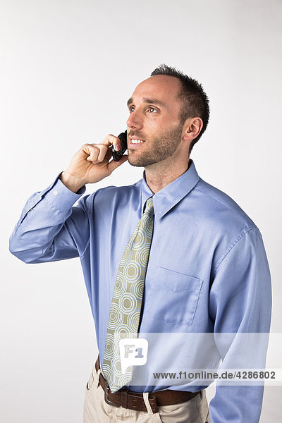 Businessman talking on cell phone  white background