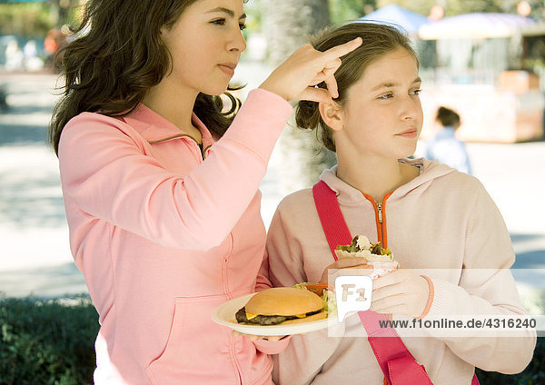 Two girls eating fast food