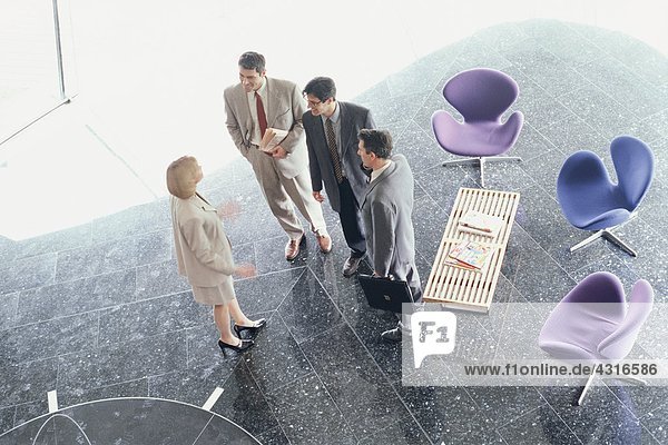 Business associates standing in lobby  high angle view